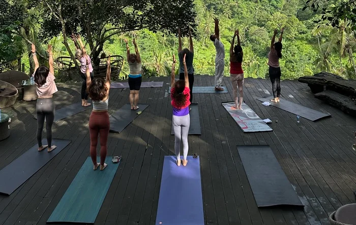students practicing surya namaskara during 200 hour yttc in bali
