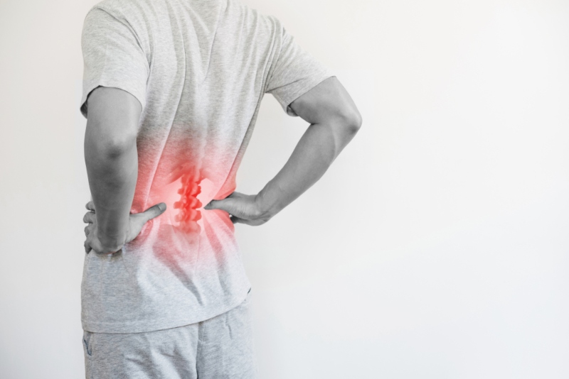 Man holding lower back in pain Man holding lower back in pain